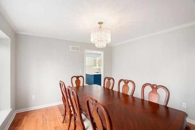 1204 Bradbury Dr, Troy, MI 48098 - dining area with a chandelier, light wood-style flooring, crown molding, and baseboards