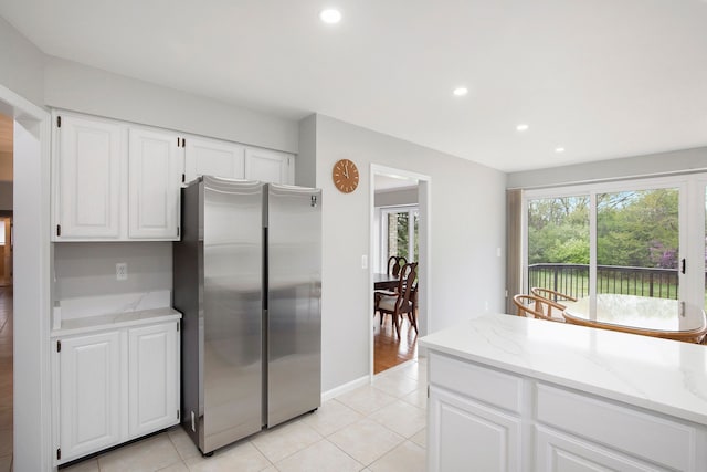 1204 Bradbury Dr, Troy, MI 48098 - kitchen featuring freestanding refrigerator, light stone countertops, light tile patterned flooring, recessed lighting, and white cabinets