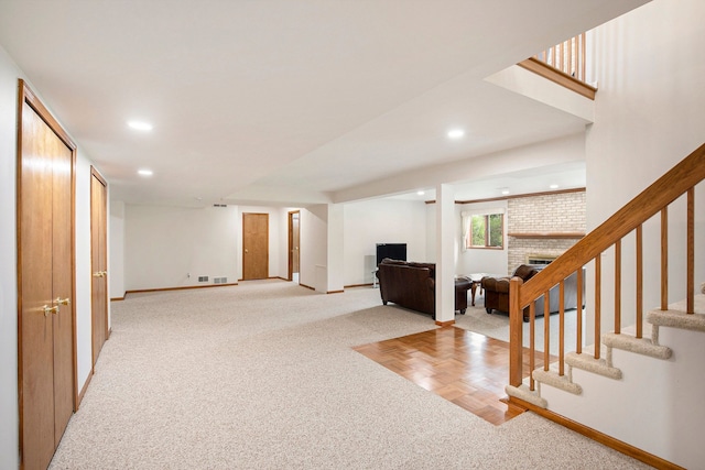 1204 Bradbury Dr, Troy, MI 48098 - below grade area featuring carpet, a brick fireplace, baseboards, stairway, and recessed lighting