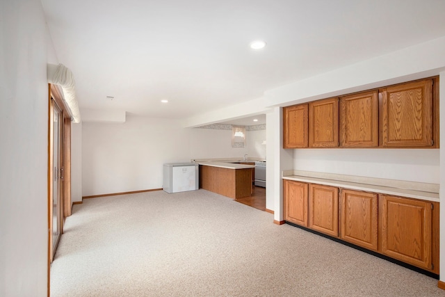 1204 Bradbury Dr, Troy, MI 48098 - kitchen with brown cabinets, light carpet, light countertops, recessed lighting, and baseboards