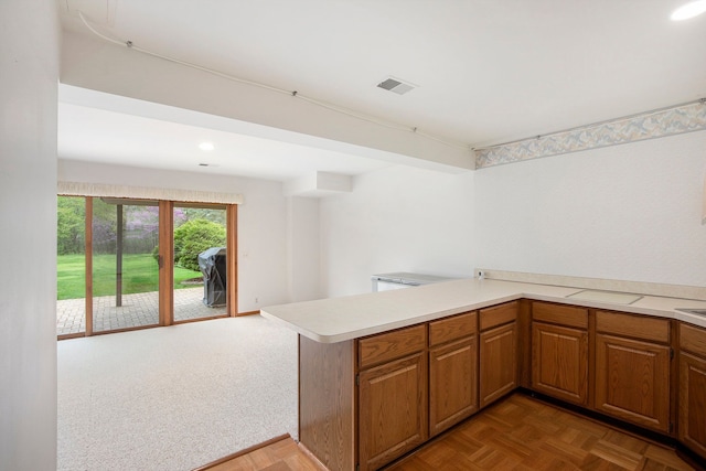 1204 Bradbury Dr, Troy, MI 48098 - kitchen featuring light countertops, a peninsula, brown cabinetry, recessed lighting, and open floor plan