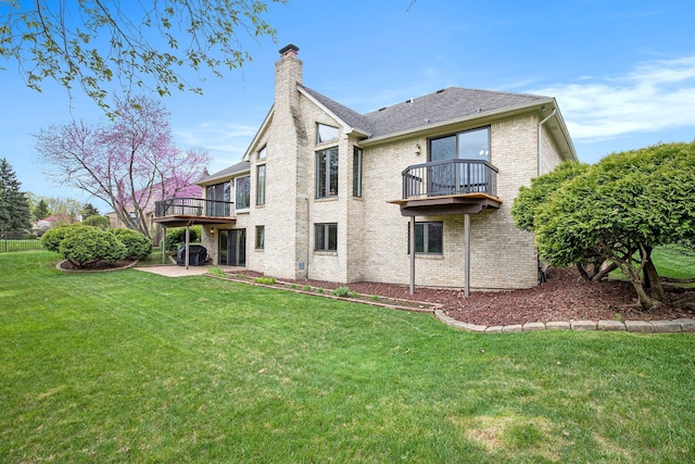 1204 Bradbury Dr, Troy, MI 48098 - back of property with a balcony, a chimney, brick siding, a yard, and a patio area