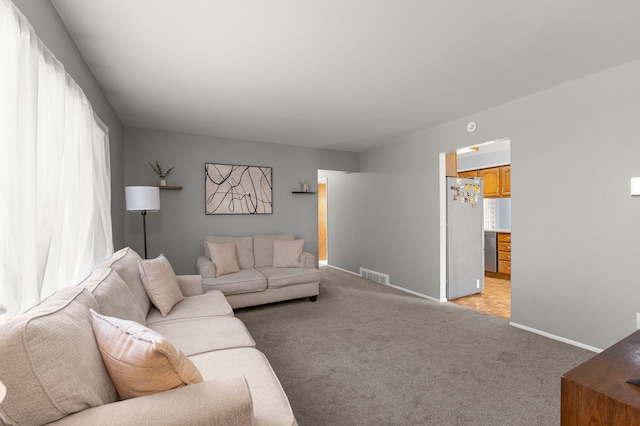 living room with light colored carpet and baseboards