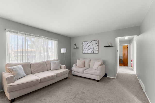carpeted living room with baseboards