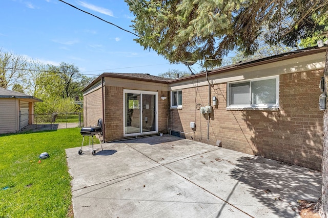 back of property with brick siding and a patio area