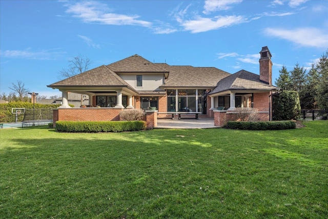 back of property featuring brick siding, a patio, a chimney, and a sunroom