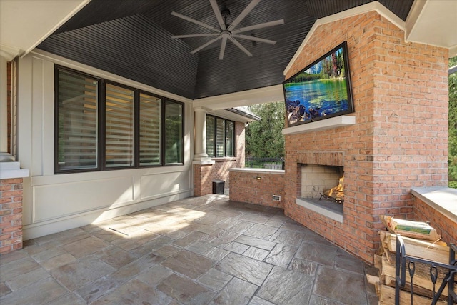 view of patio / terrace with an outdoor brick fireplace and a ceiling fan