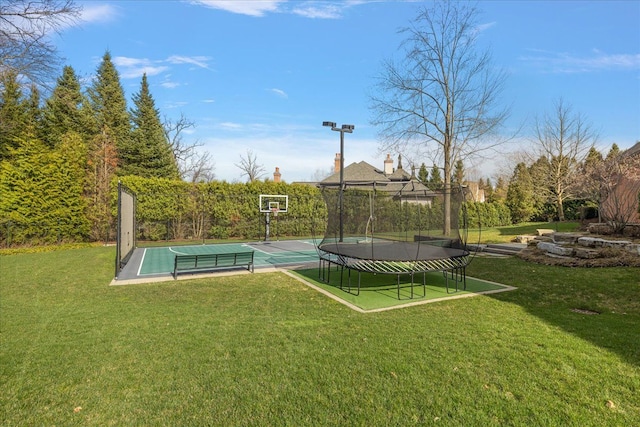 view of sport court featuring a lawn