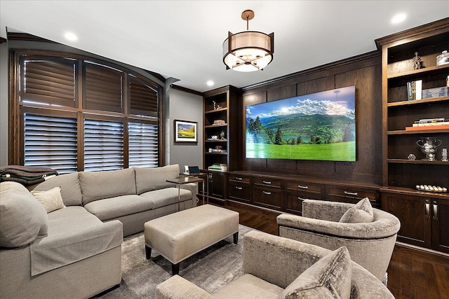 living room with dark wood finished floors, ornamental molding, built in features, and recessed lighting