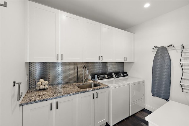washroom featuring washing machine and dryer, cabinet space, dark wood-style flooring, baseboards, and recessed lighting