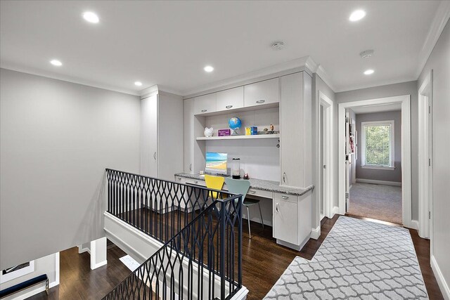 corridor featuring baseboards, dark wood finished floors, crown molding, recessed lighting, and a desk