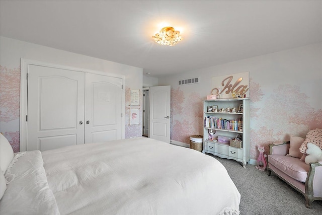 bedroom featuring light colored carpet, a closet, and baseboards