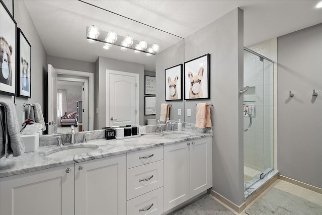 full bath featuring a stall shower, double vanity, baseboards, and tile patterned floors
