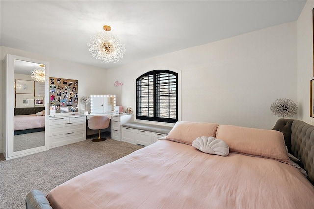carpeted bedroom with a chandelier and an office area