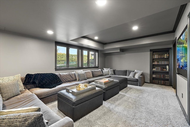 carpeted living room with ornamental molding, recessed lighting, and a tray ceiling