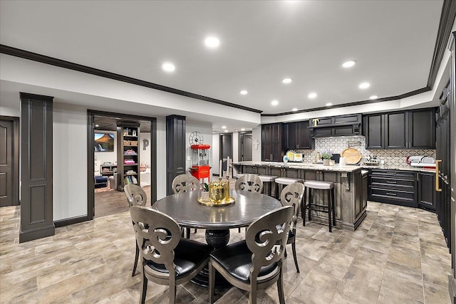 dining area with crown molding and recessed lighting