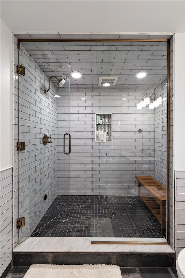 bathroom with a shower stall and toilet