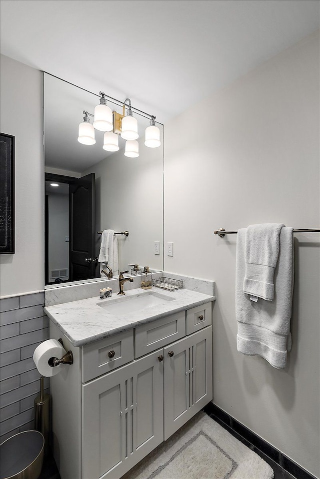 bathroom featuring vanity, tile walls, and wainscoting
