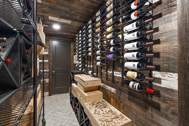 wine room with brick patterned flooring and wood ceiling