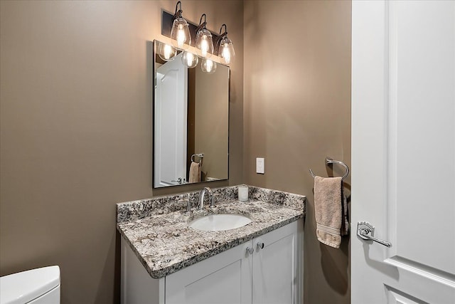 bathroom with toilet and vanity