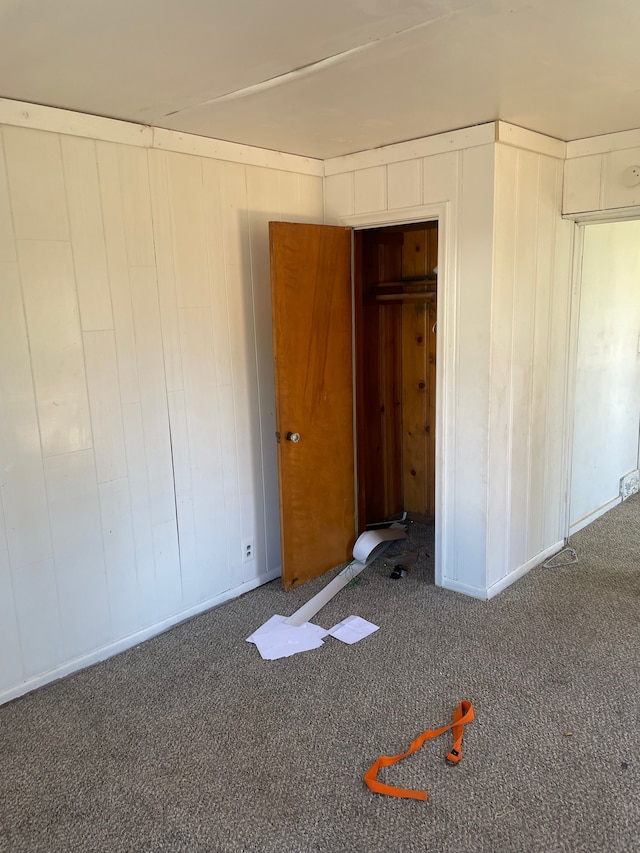 unfurnished bedroom featuring carpet and baseboards