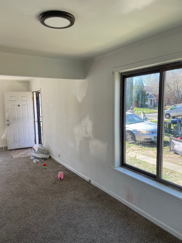 carpeted empty room with baseboards