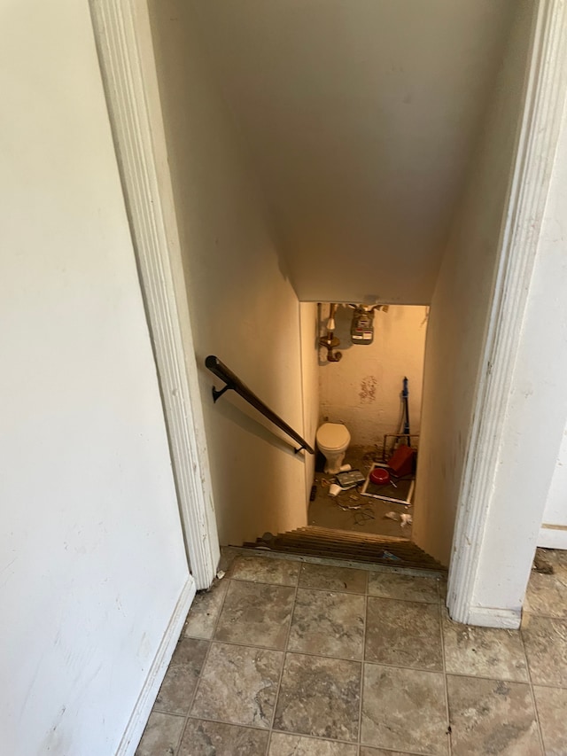 staircase with stone finish flooring