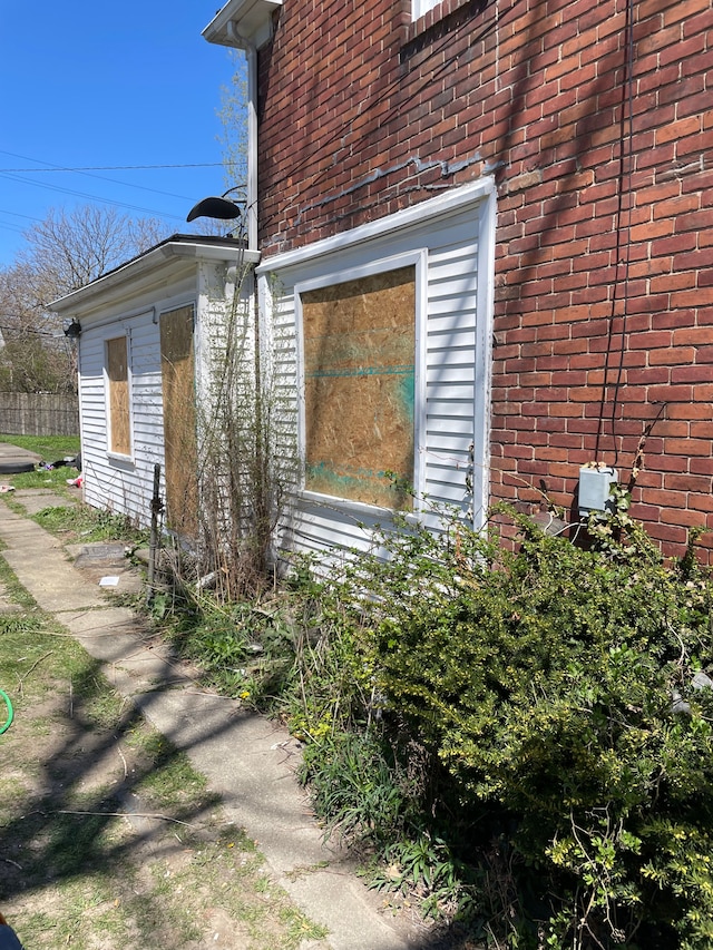 view of side of home featuring brick siding