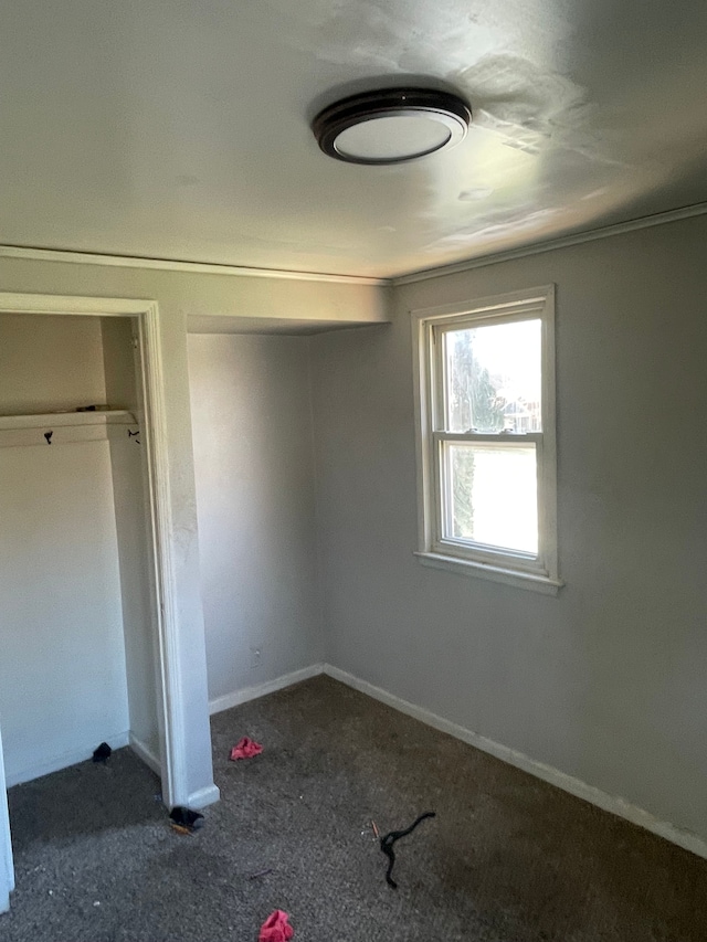 unfurnished bedroom with carpet and baseboards