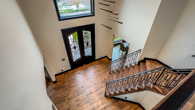 47490 Bellagio Dr, Northville, MI 48167 - foyer entrance featuring wood finished floors, a high ceiling, french doors, stairway, and baseboards