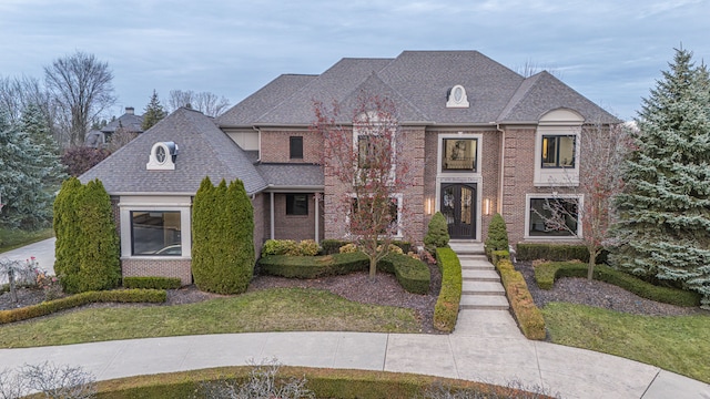 47490 Bellagio Dr, Northville, MI 48167 - view of front of property featuring brick siding, a front lawn, and a shingled roof