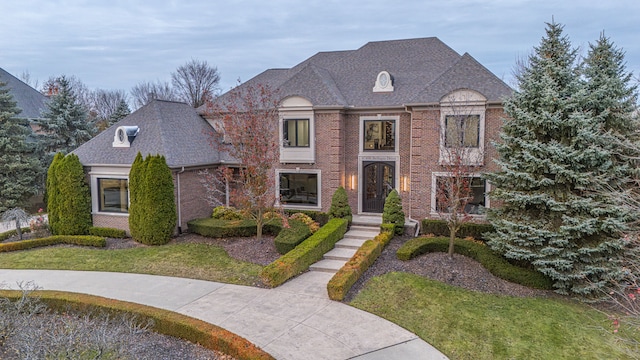 47490 Bellagio Dr, Northville, MI 48167 - french country style house featuring brick siding, roof with shingles, and a front yard