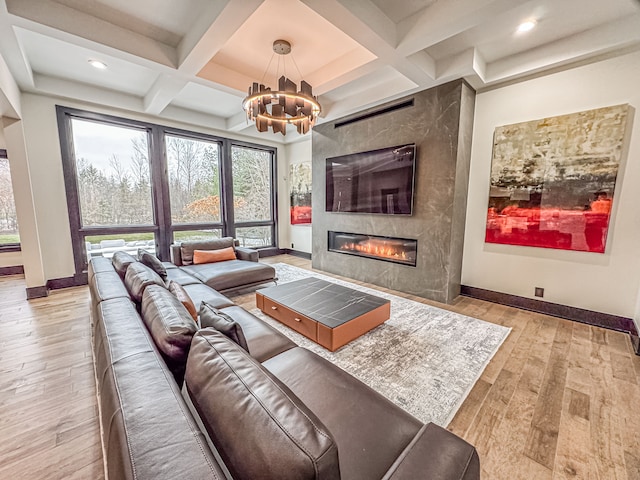 47490 Bellagio Dr, Northville, MI 48167 - living room with baseboards, a chandelier, wood finished floors, coffered ceiling, and a high end fireplace