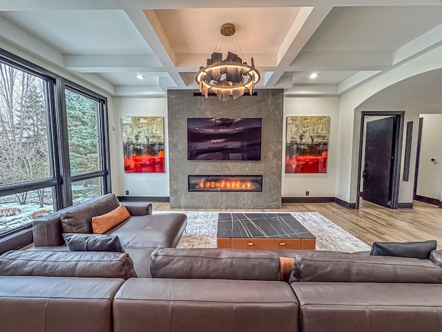 47490 Bellagio Dr, Northville, MI 48167 - living room with wood finished floors, a chandelier, a premium fireplace, baseboards, and coffered ceiling