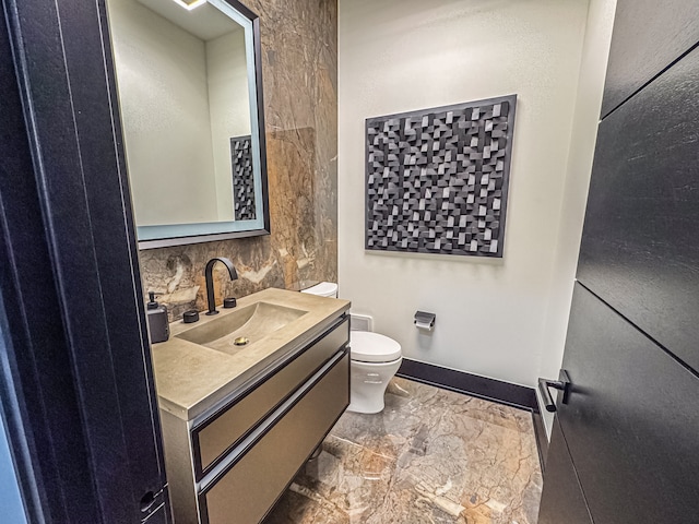 47490 Bellagio Dr, Northville, MI 48167 - half bathroom with toilet, marble look tiles, vanity, and baseboards
