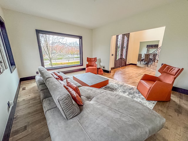 47490 Bellagio Dr, Northville, MI 48167 - living room featuring baseboards, wood finished floors, and stairway