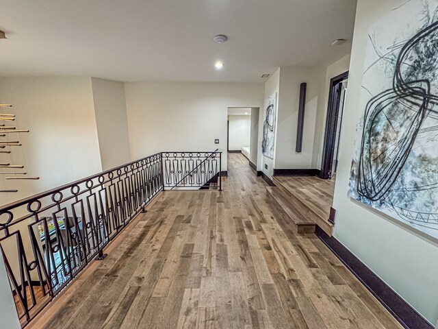 47490 Bellagio Dr, Northville, MI 48167 - hall featuring wood finished floors, an upstairs landing, baseboards, and recessed lighting