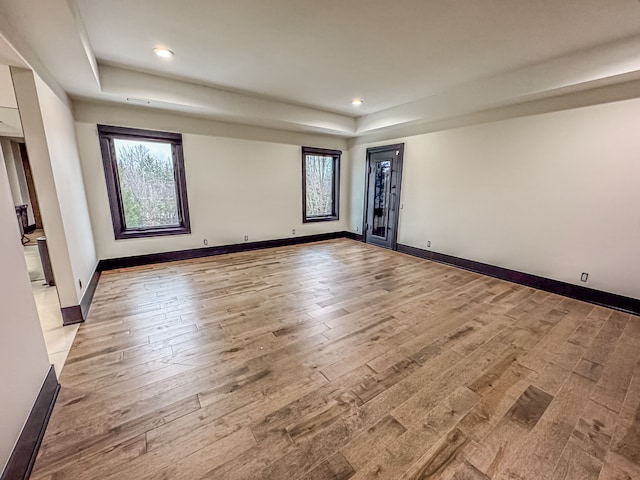 47490 Bellagio Dr, Northville, MI 48167 - spare room with a raised ceiling, plenty of natural light, hardwood / wood-style floors, recessed lighting, and baseboards