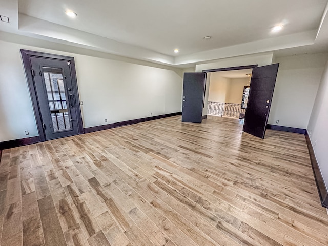 47490 Bellagio Dr, Northville, MI 48167 - unfurnished room featuring a raised ceiling, light wood-type flooring, baseboards, and recessed lighting