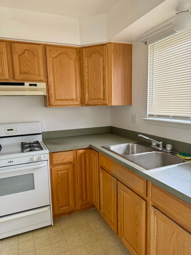 1349 Cherrylawn Dr, Pontiac, MI 48340 - kitchen featuring white gas stove, under cabinet range hood, a sink, and light tile patterned floors