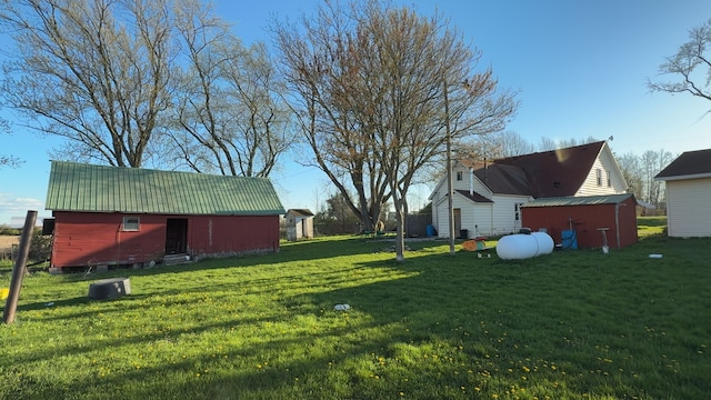view of green lawn with an outdoor structure and a shed