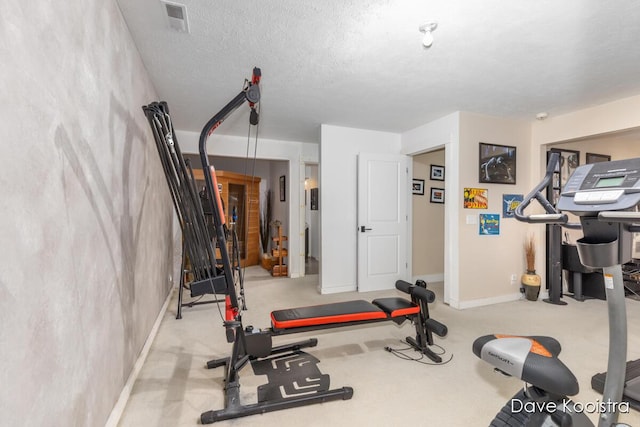 workout room with baseboards and carpet