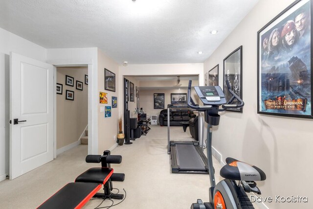workout room featuring baseboards and carpet flooring
