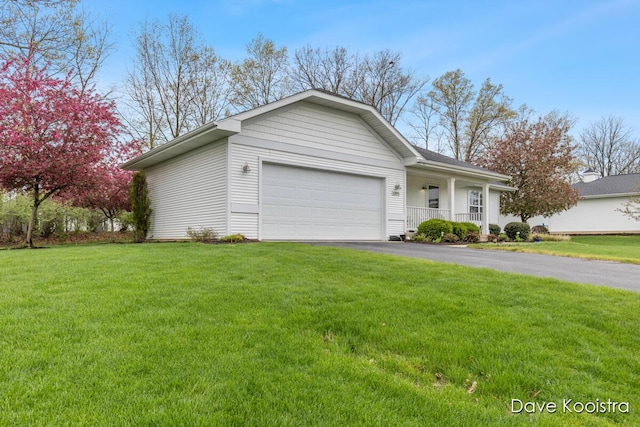 ranch-style house featuring a garage, asphalt driveway, a front yard, and covered porch