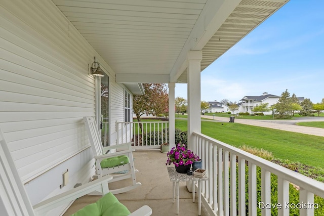 view of patio featuring covered porch and a residential view