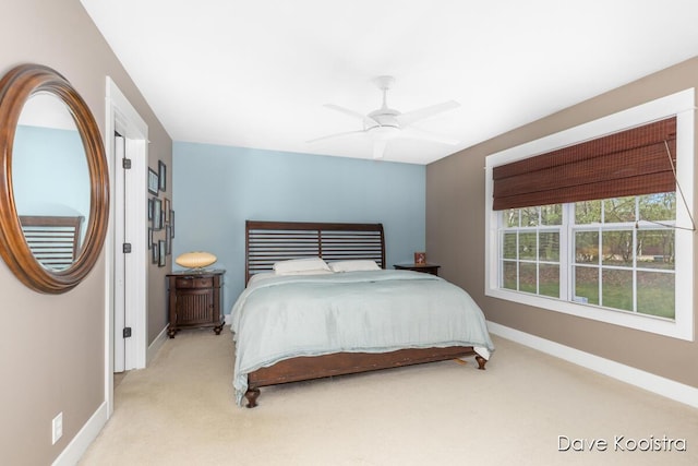 carpeted bedroom featuring baseboards and ceiling fan