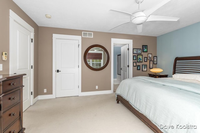 bedroom featuring light colored carpet, baseboards, and a ceiling fan