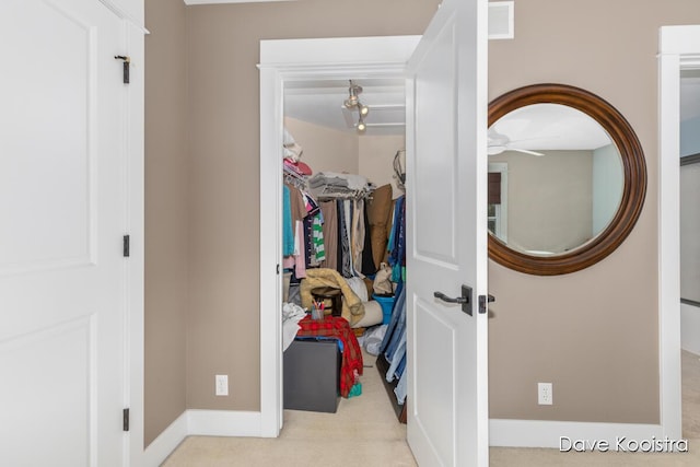 spacious closet with ceiling fan