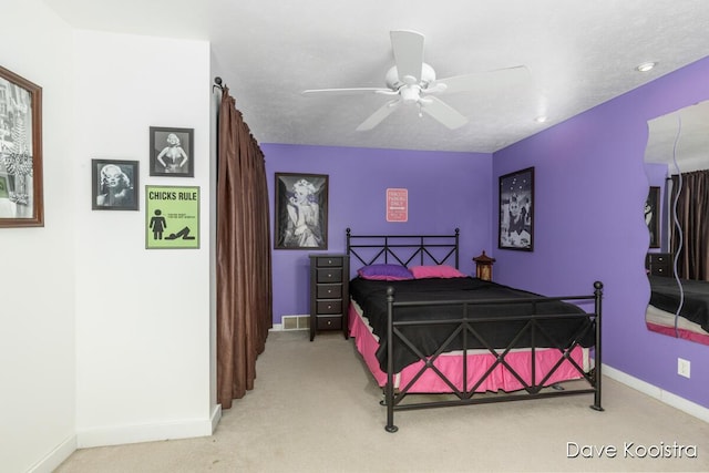 carpeted bedroom featuring baseboards and a ceiling fan