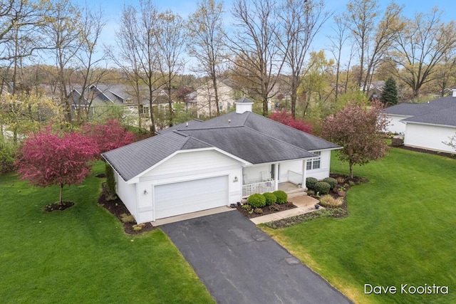 view of front of property featuring a porch, a front lawn, a garage, and asphalt driveway